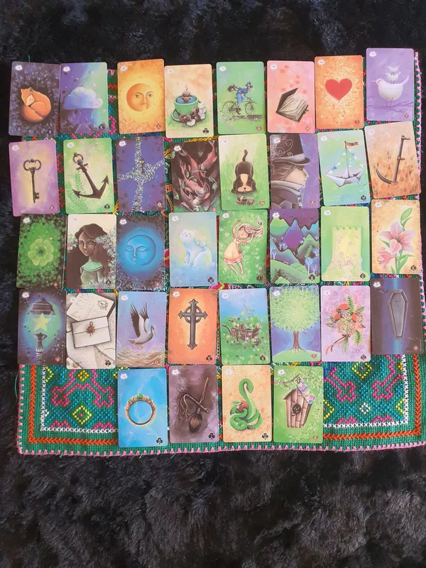 A 36-card Lenormand Grand Tableau on a green and blue mat.