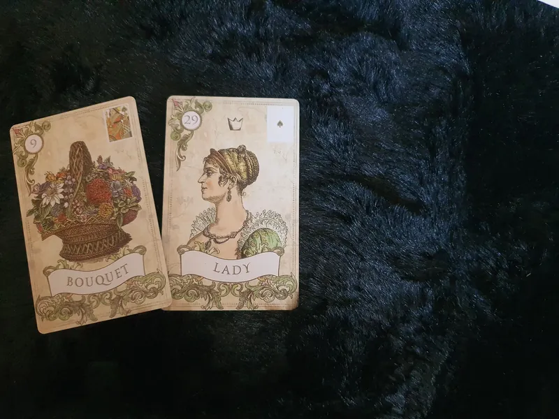 Bouquet and Woman from Old Style Lenormand, placed together on a blue-black cloth.